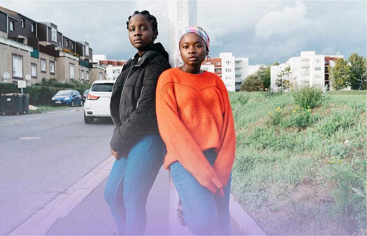 Two women posing in street and looking at camera